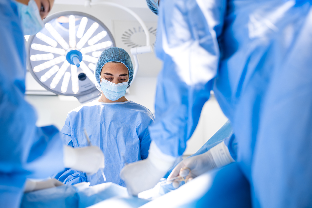 Doctor and assistant nurse operating on a patient from dangerous emergency case.